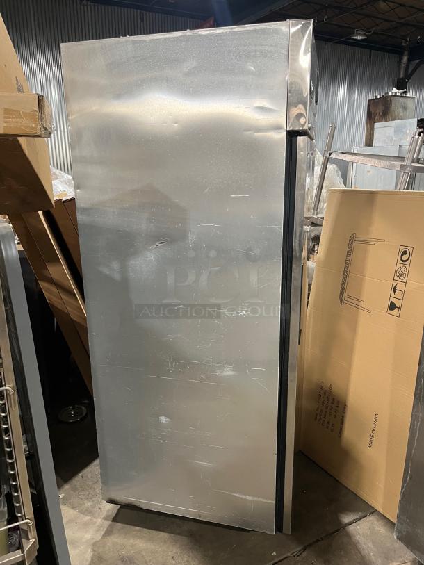 True TG1R-1S stainless steel single door refrigerator, commercial grade, with poly-coated wired rack, on casters.