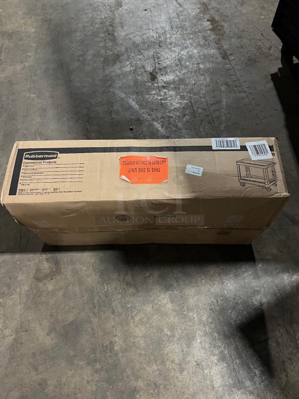 NEW! Rubbermaid FG9T6600BLA Black Heavy Duty 2-Tier Utility Pushcart in box. Box shows product image and labels.