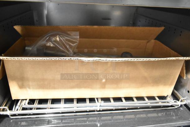 Cardboard box inside Vulcan 72SS-6B36GP range oven, indicating storage or accessory inclusion. Stainless steel, 6 burners, flat top.