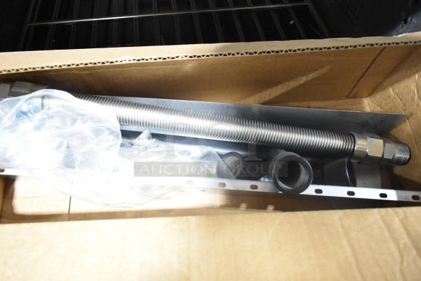 Stainless steel flexible gas connector and fittings in cardboard box.