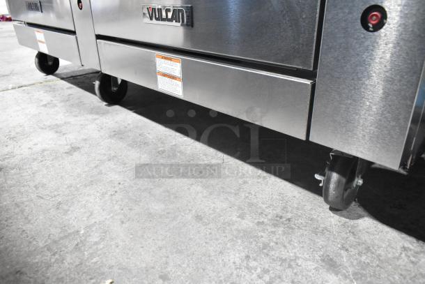 Vulcan 72SS-6B36GP stainless steel commercial range with 6 burners, flat top griddle, 2 ovens, over shelf, back splash, and casters.