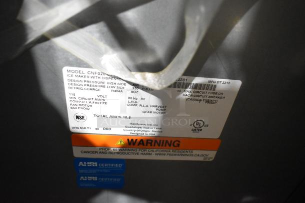 Label on Manitowoc CNF0201A-161L stainless steel commercial ice maker; model details and safety warnings visible.