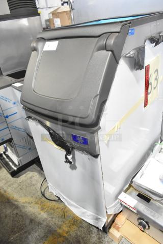 Brand new Manitowoc D420 stainless steel ice bin, 383 lbs capacity, with minor scratches and dents. Model label visible.