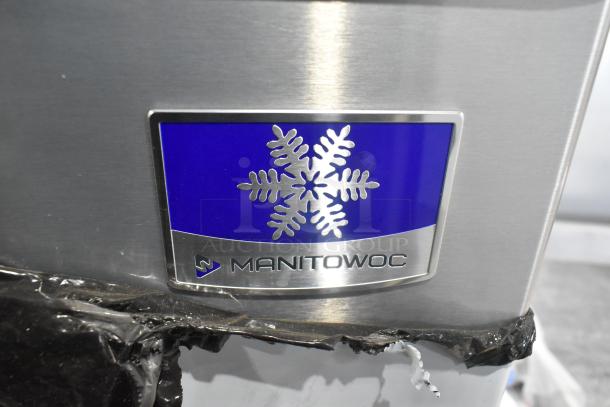 Brand new Manitowoc D420 stainless steel ice bin, 383 lbs capacity, with visible branding. Scratch and dent condition.