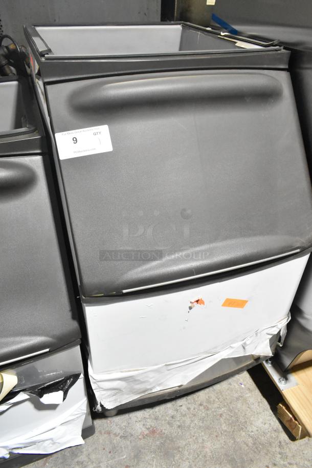 Manitowoc B320 ice bin, 210 lb capacity, stainless steel, new with scratches and dents, tags visible.