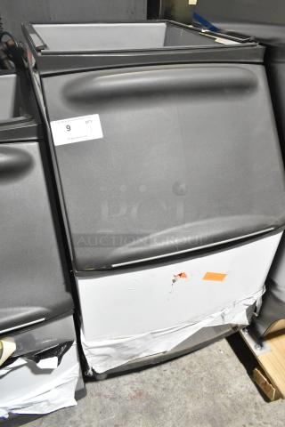 Manitowoc B320 ice bin, 210 lb capacity, stainless steel, new with scratches and dents, tags visible.
