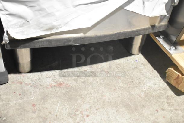 Stainless steel Manitowoc B320 ice bin, 210 lb capacity, scratch and dent condition, partially covered, on pallet.