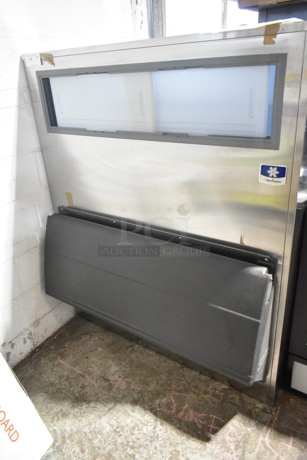 Brand new Manitowoc stainless steel commercial ice bin, scratch and dent condition, features front access door.
