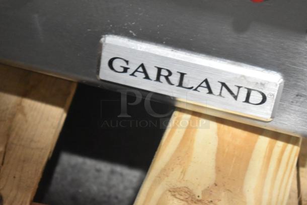 Garland stainless steel commercial countertop flat top griddle with visible brand label.