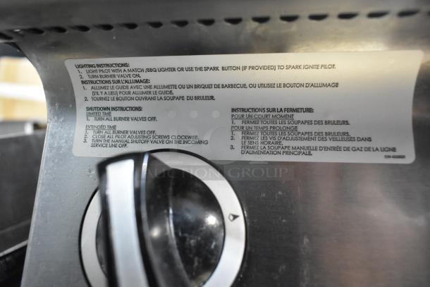 Garland Stainless Steel Commercial Griddle with visible lighting and shutdown instructions, sturdy condition.