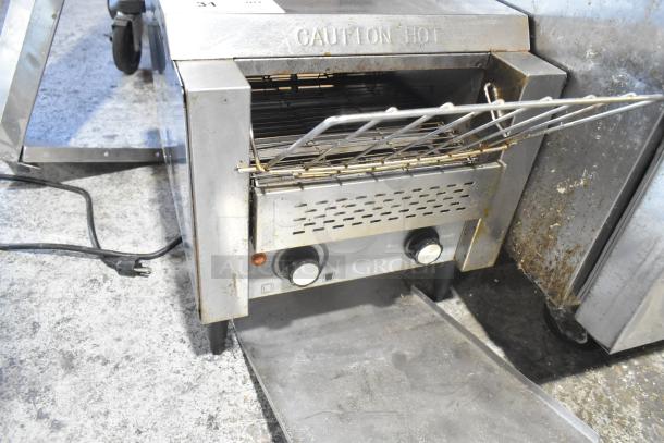 AvaToast CTA7001 stainless steel commercial countertop conveyor toaster oven, 120 volts, 1 phase. Visible wear, caution hot label.