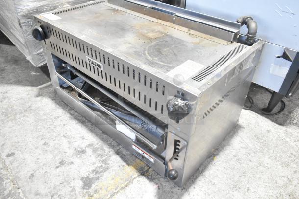 Vulcan Stainless Steel Commercial Cheese Melter, showing signs of use. Features control knobs and ventilation slots.