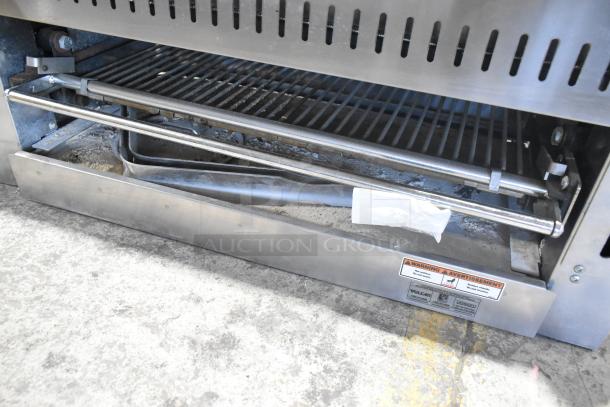 Vulcan Stainless Steel Commercial Cheese Melter, used condition, with visible grills and heating element. Safety warning label present.