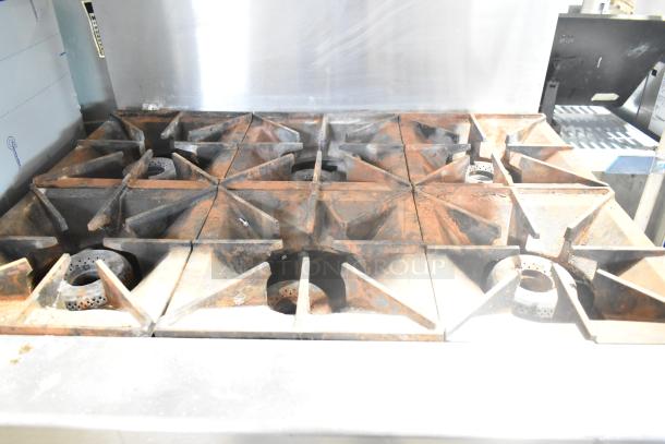 Vulcan stainless steel 6-burner gas range with oven, over shelf, and back splash; used, with visible wear.