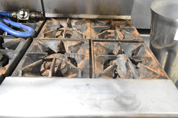 Tri-Star TSR-1 stainless steel commercial range with 4 burners, oven, and salamander melter. Shows signs of use.
