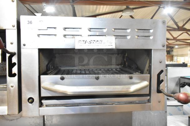 Tri-Star TSR-1 stainless steel commercial range with 4 burners, oven, salamander cheese melter, and backsplash. Model tag visible.