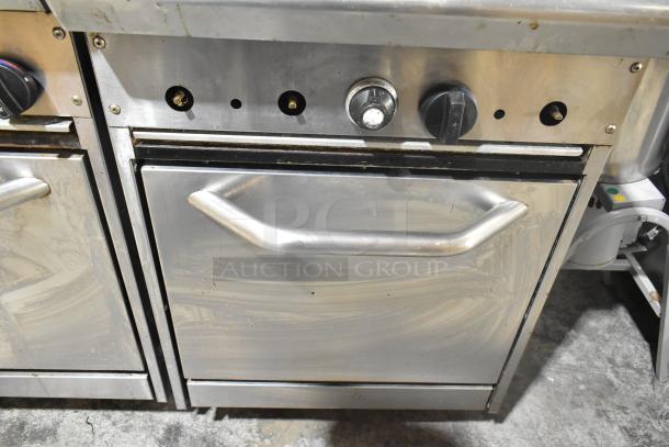 Tri-Star TSR-1 stainless steel 4 burner range with oven, salamander cheese melter, and backsplash, natural gas powered.