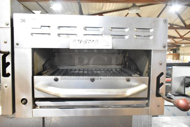 Tri-Star TSR-1 stainless steel commercial 4-burner range with oven, salamander cheese melter, and backsplash. Visible wear.