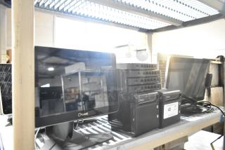 10 various Toast items including 4 POS monitors, 2 receipt printers, 4 port units, in used condition on metal shelf.