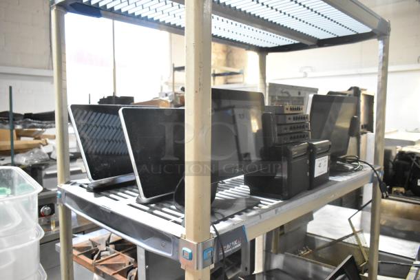 10 items including 4 Toast POS monitors, 2 Toast receipt printers, and 4 port units on a metal shelf. Good condition.