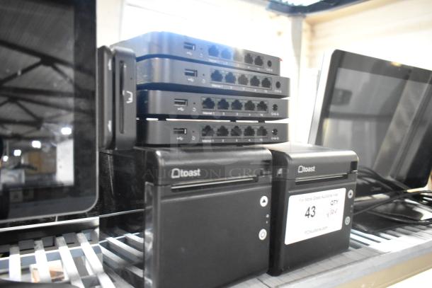 Auction item: 4 Toast POS monitors, 2 Toast receipt printers, 4 port units. Includes labels, excellent condition.