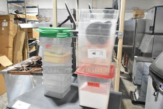 Lot of 13 poly storage bins with lids, varying colors, and visible labels, ideal for organization or storage.