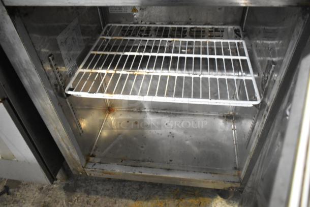 Avantco 178SSWT27FHC stainless steel undercounter freezer, single door, on commercial casters. Visible wear and interior rust.