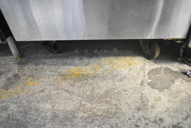 Avantco 178SSWT27FHC stainless steel undercounter freezer on casters, visibly worn, suitable for commercial use, 115V.