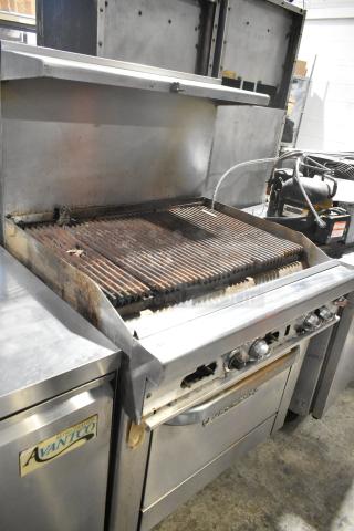 Southbend 436D-3C stainless steel commercial gas charbroiler grill with oven, overshelf, and backsplash on casters. Used condition.