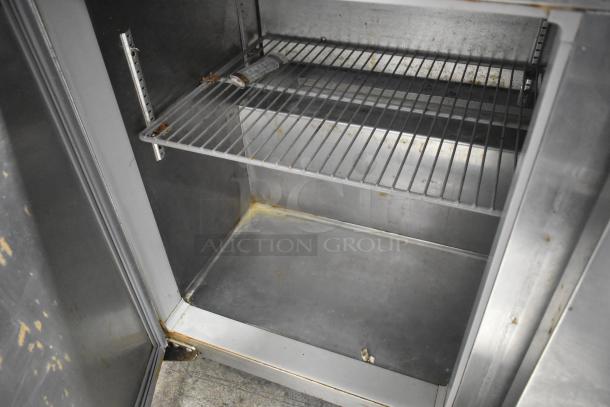 Continental SW48-AS stainless steel undercounter cooler interior, showing shelving. Visible wear on surfaces. 115 volts, 1 phase.