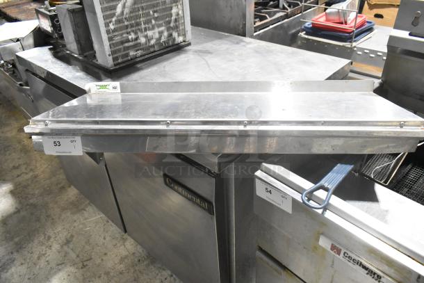 Stainless steel Regency 600WS1236HD wall mount shelf, used condition, with visible NSF certification label.
