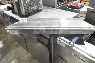 Stainless steel Regency 600WS1236HD wall mount shelf, used condition, with visible NSF certification label.