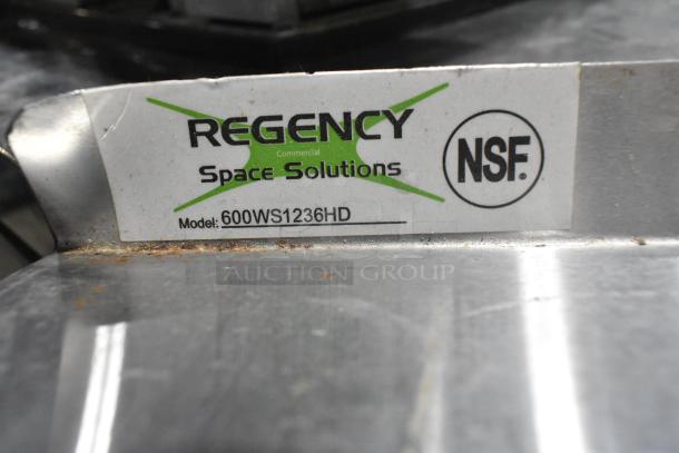 Regency 600WS1236HD stainless steel wall mount shelf, visible NSF label, slight wear on surface.