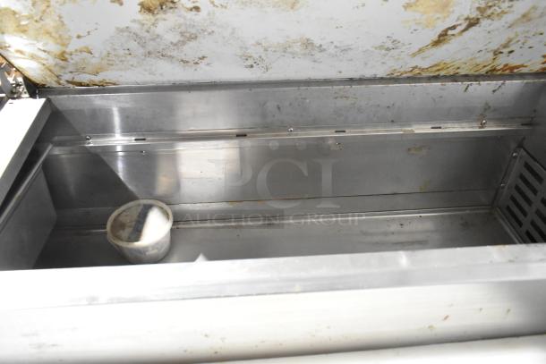 Avantco 178PICL2 stainless steel pizza prep table, used condition, showing interior compartment with signs of wear.