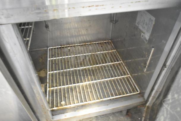 Avantco 178PICL2 Stainless Steel Pizza Prep Table's interior, showing wire shelving and some wear. 115 Volts, 1 Phase model.