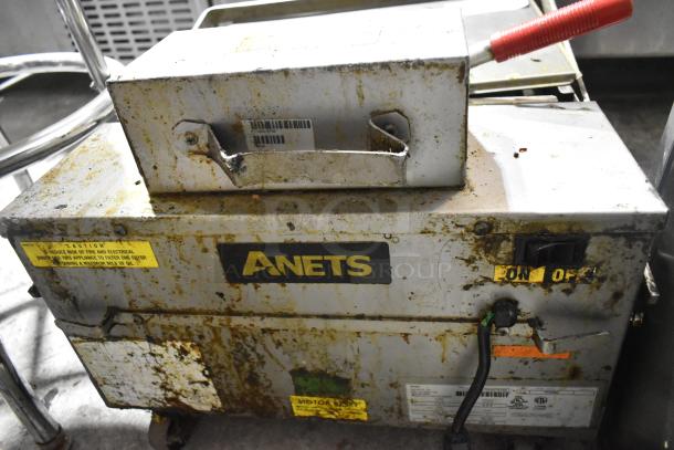 2017 Anets FFM80 stainless steel fryer filter, 80 lb capacity, commercial casters, visible wear, labels intact, 115V, 1 phase.