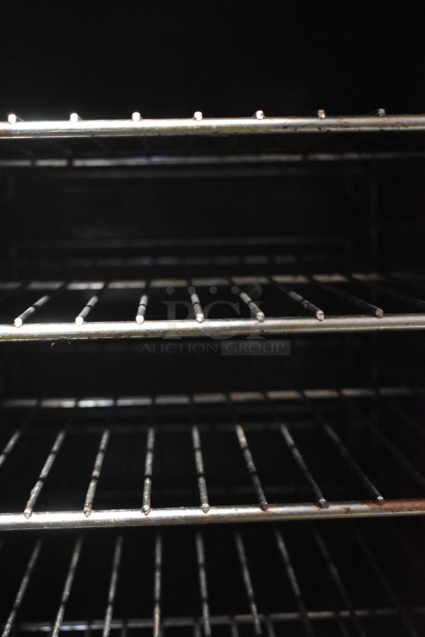 Vulcan stainless steel convection oven interior with metal racks, showing commercial-grade quality and ample cooking space.