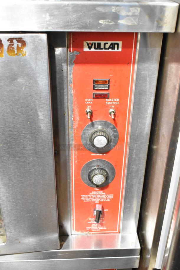 Vulcan stainless steel commercial gas-powered half-size convection oven control panel with switches and knobs. Signs of wear visible.