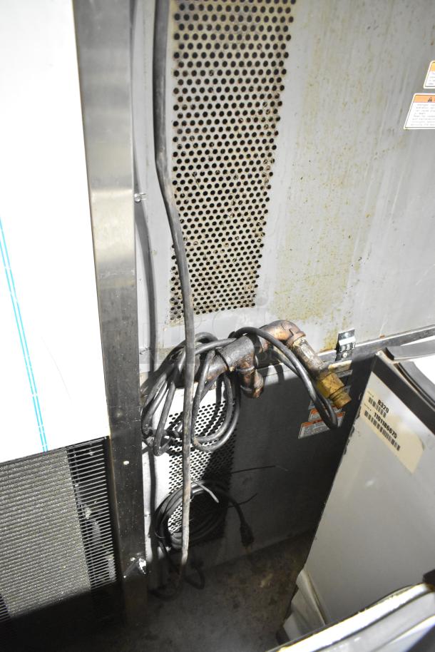 Vulcan stainless steel commercial gas convection oven back view, shows cords, vents, and labels indicating model details.