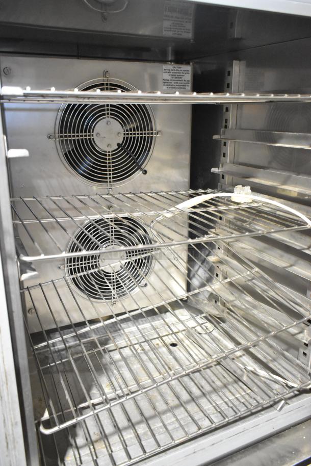 Norlake Stainless Steel Commercial Blast Chiller with wire racks, dual fans, and caution labels, in good condition.