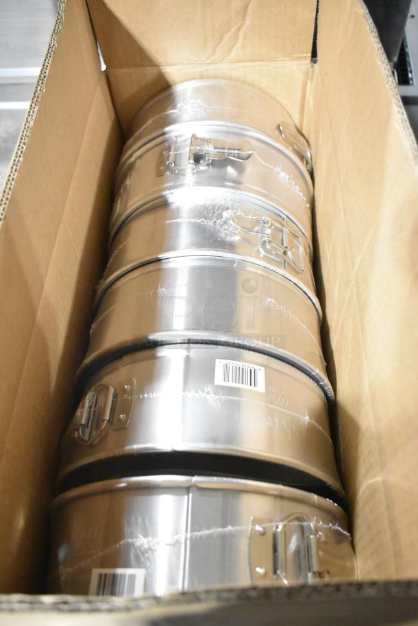 Brand new Focus 900408 8" springform flat pans in box, showing metal clasps and barcode labels.