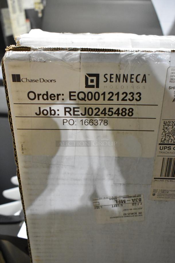 Box labeled "Chase Doors Senneca REJ0245488," containing new CZN-6-S-4086 strip door curtain. Order EQ00121233.