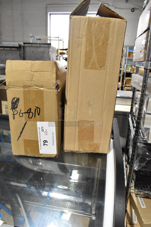 Two sealed boxes containing a new Update TD-MFOLD Surface Mount Paper Towel Dispenser and an Update PG810 Wire Pan Grate.