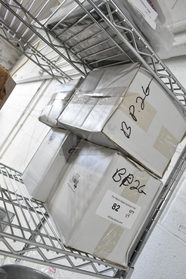 Four boxed brand new Update BP-2G 64 oz stainless steel pitchers with ice guards on metal shelving. Labels indicate "QTY x4."
