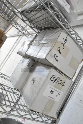 Four boxed brand new Update BP-2G 64 oz stainless steel pitchers with ice guards on metal shelving. Labels indicate "QTY x4."
