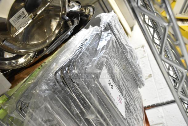 30 new Update PG810 1/2 size wire pan grates, packaged and stacked. Labels indicate quantity and auction info.
