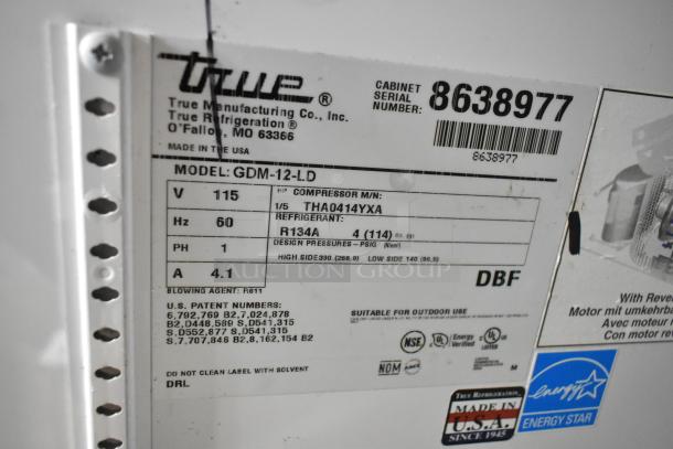 True GDM-12-LD cooler label, 115V, 1 phase. Shows model, refrigerant type (R134A), pressure details, serial number 8638977.