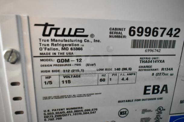 True GDM-12 cooler label showing model, voltage 115, phase 1, refrigerant R134A, and serial number 6996742.