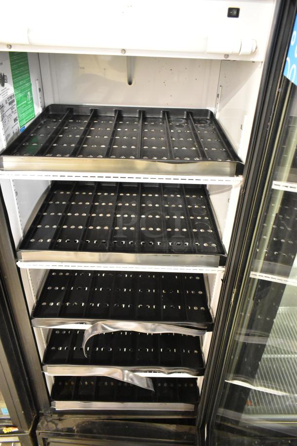 True GDM-12 commercial cooler with single glass door, poly-coated racks, 115V, metal exterior. Clean, good condition.
