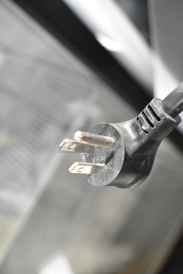 Close-up of a three-prong plug for the 2023 True GDM-12-HC commercial cooler merchandiser, 115 volts, 1 phase.